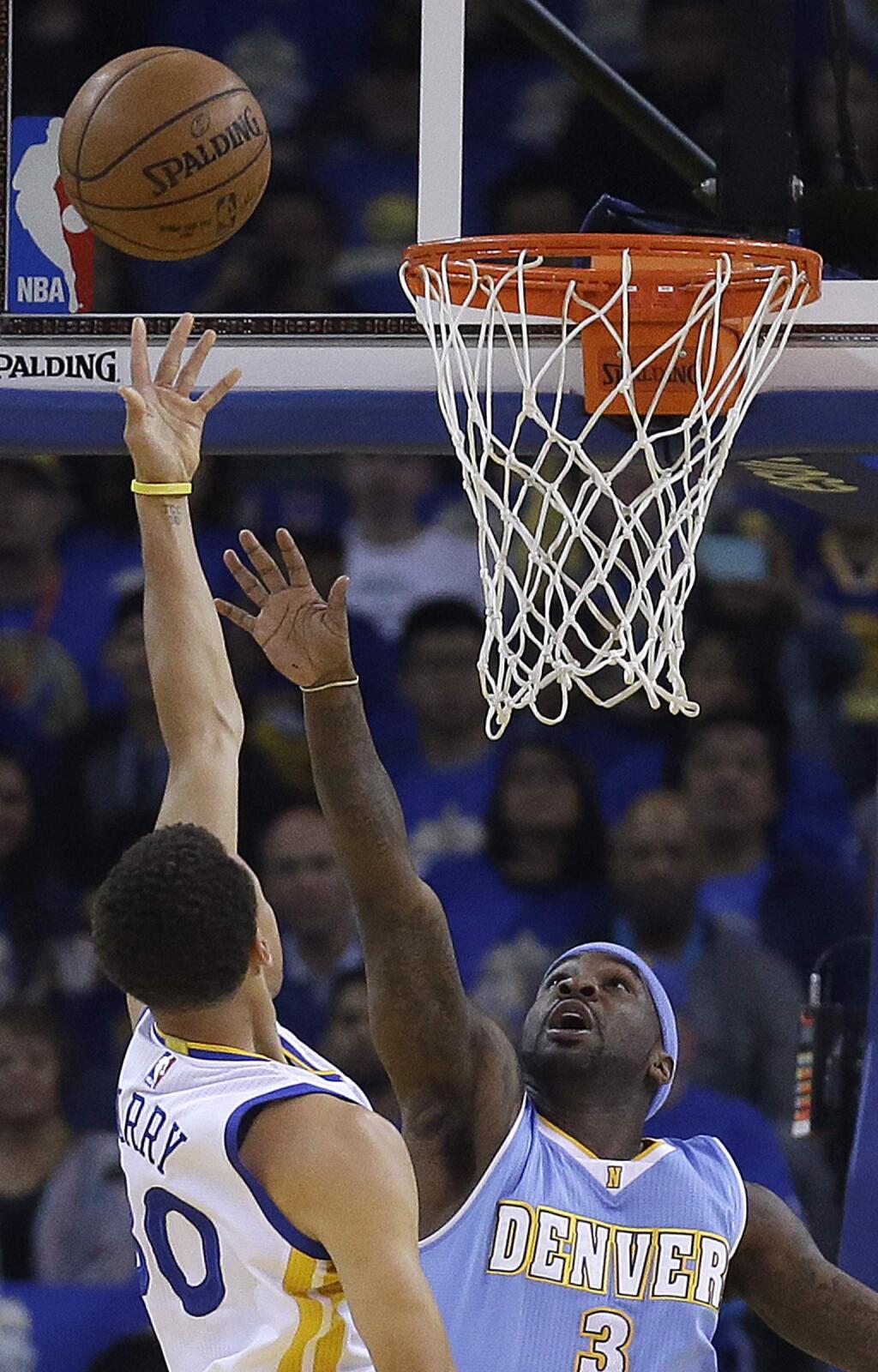 Denver Nuggets' Ty Lawson, right, defends against a shot by Golden State Warriors' Stephen Curry (30) during the first half of an NBA basketball game Wednesday, April 15, 2015, in Oakland, Calif. (AP Photo/Ben Margot)