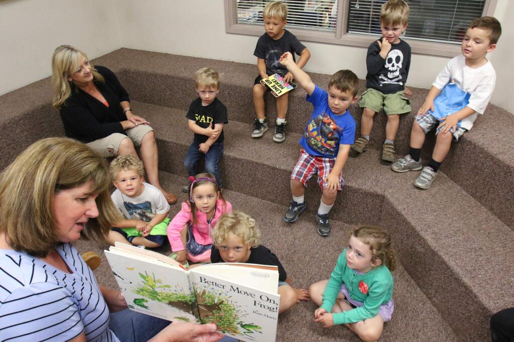 Mary Collins School at Cherry Valley Librarian April Derby reads to the children and teacher Karen Nau of the North Bay Children's Center preschool at Cherry Valley campus in Petaluma on Tuesday, August 18, 2015. (SCOTT MANCHESTER/ARGUS-COURIER STAFF)