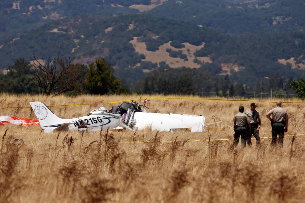 Sonoma County Sheriff's Deputies secure a perimeter around the site of a fatal airplane crash near Schellville, California on Thursday, July 13, 2017. (Alvin Jornada / The Press Democrat)