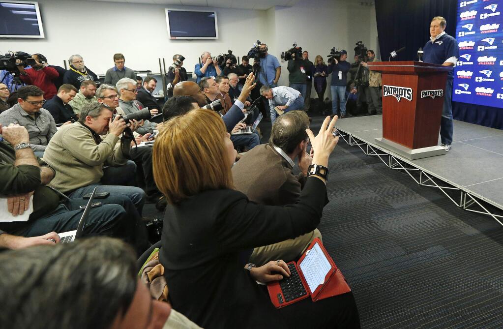 New England Patriots head coach Bill Belichick, right, faces members of the media during a news conference prior to a team practice in Foxborough, Mass., Thursday, Jan. 22, 2015. (AP Photo/Elise Amendola)
