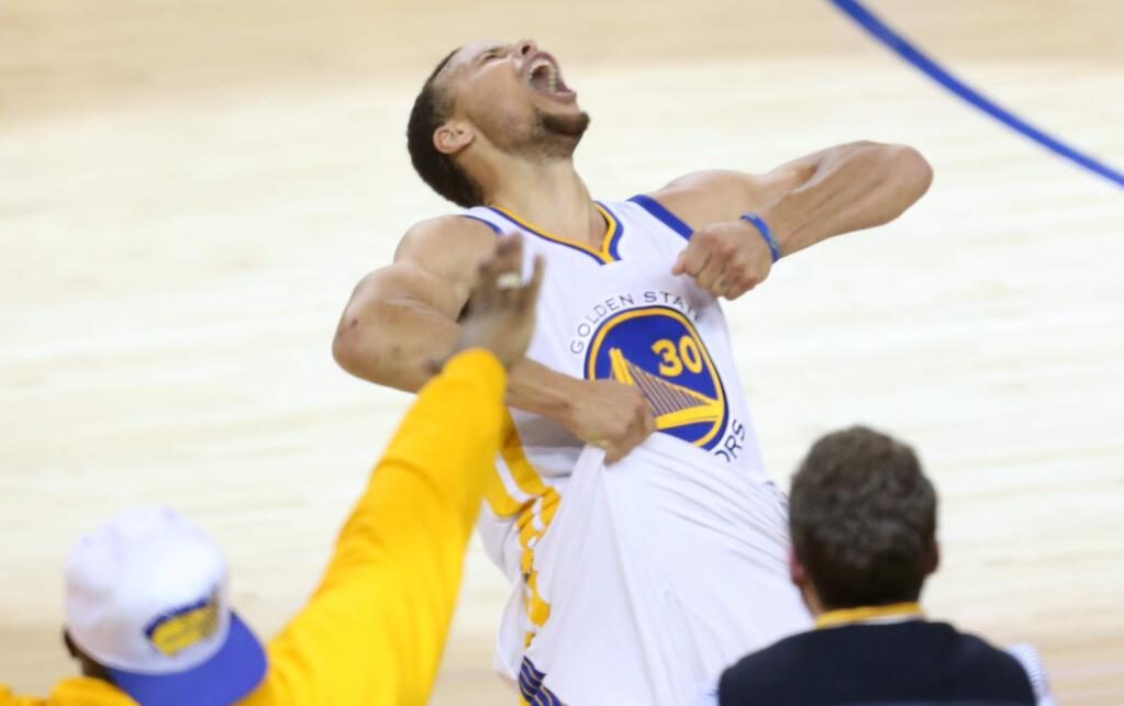 Golden State Warriors' Stephen Curry lets out a yell after hitting a three-point shot against the Oklahoma City Thunder, during their game in Oakland on Monday, May 30, 2016. The Warriors defeated the Thunder 96-88. (Christopher Chung / The Press Democrat)