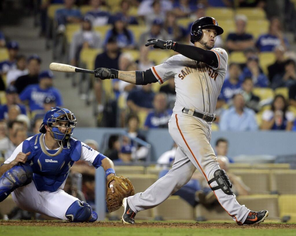 San Francisco Giants' Gregor Blanco hits a two-run double during the 13th inning of a baseball game against the Los Angeles Dodgers Monday, Sept. 22, 2014, in Los Angeles. (AP Photo/Jae C. Hong)