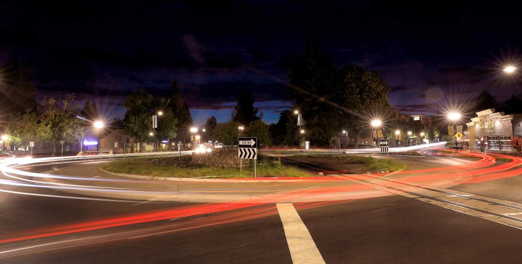 A long-exposure photograph captures headlights and taillights at the Healdsburg roundabout on Monday, Aug. 5, 2019. (KENT PORTER/ PD)