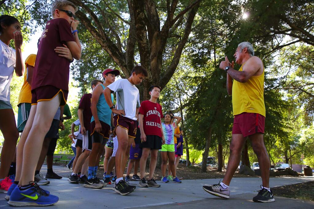 Piner cross country coach Luis Rosales gives his team training instructions before they head out for their run at Howarth Park in Santa Rosa, on Thursday, June 23, 2016. (Christopher Chung / The Press Democrat)
