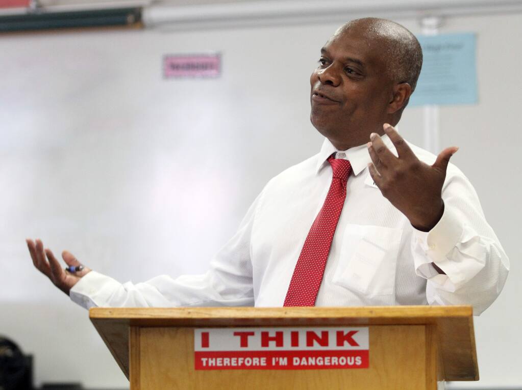 Vince Harper of Community Action Partnership talks to Elsie Allen High School students prior to sending them out in their own neighborhoods to photo document things they like and dislike about their neighborhood, Monday, Aug. 25, 2014. (Crista Jeremiason / The Press Democrat, 2014)