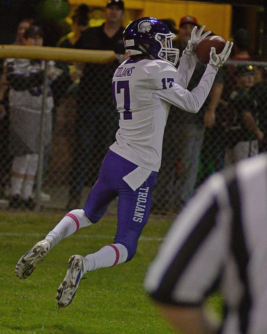 SUMNER FOWLER/FOR THE ARGUS-COURIERPetaluma's Daxton Hogya grabs a touchdown pass from Cole Powers to starft the Trojans to a 30-12 win over Sonoma Valley.