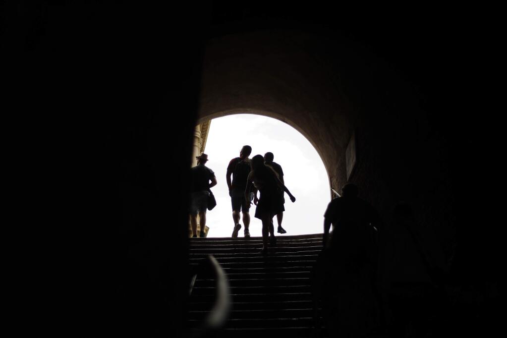 Tourists walks up the steps leading to St. Peter in Chains Basilica, in downtown Rome, Saturday, July 21, 2018. (AP Photo/Gregorio Borgia)