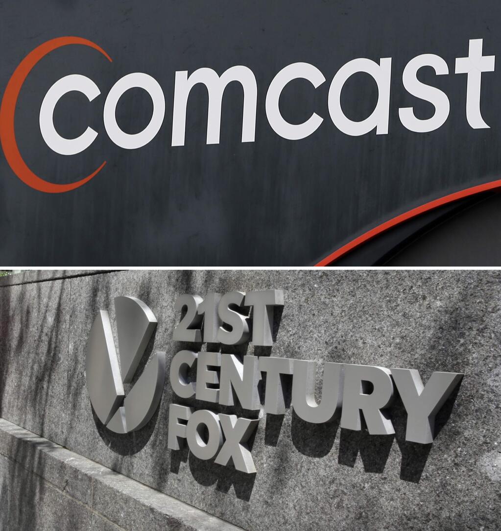 FILE- This combo of file photos shows the 21st Century Fox sign outside of the News Corporation headquarters building on Aug. 1, 2017, in New York, bottom, and a Comcast sign on Oct. 12, 2017, in Hialeah, Fla. Comcast is making a $65 billion bid for Fox's entertainment businesses, setting up a battle with Disney to become the next mega-media company. (AP Photo/File)