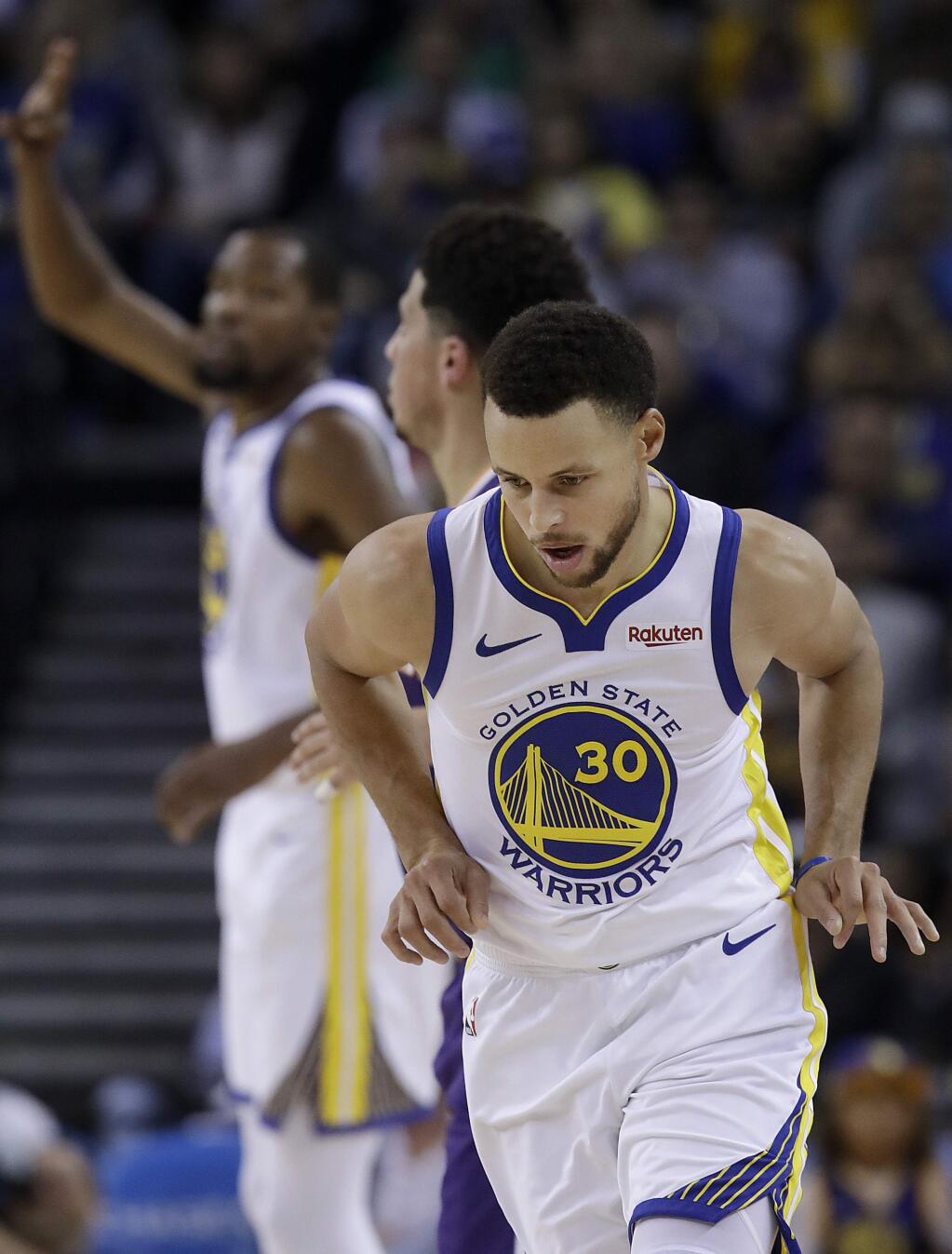 Golden State Warriors guard Stephen Curry (30) gestures after scoring against the Phoenix Suns during the first half of an NBA basketball game in Oakland, Calif., Monday, Oct. 22, 2018. (AP Photo/Jeff Chiu)