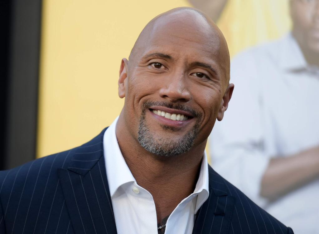 FILE - In this June 10, 2016 file photo, Dwayne Johnson attends the premiere of his film, 'Central Intelligence' in Los Angeles. Johnson is the highest-paid actor with a fast and furious income of $64.5 million, according to Forbes magazine. Johnson, the former wrestler whose income swelled thanks to the films “Central Intelligence” and “Fast 8,” beat out Jackie Chan with $61 million and Matt Damon, who earned $55 million. (Photo by Richard Shotwell/Invision/AP, File)