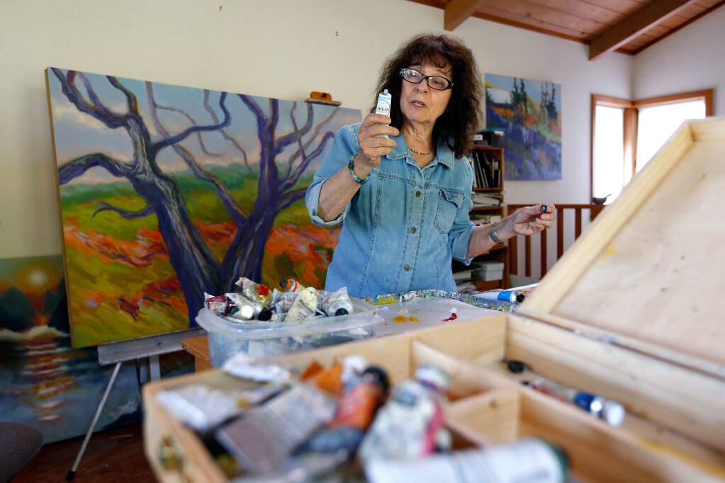 Artist Marsha Connell chooses colors as she continues work on a Giving Tree painting for the Jewish Community Free Clinic at her studio in Santa Rosa, California, on Thursday, May 19, 2016. (Alvin Jornada / The Press Democrat)