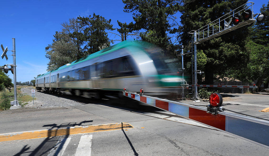 A southbound SMART train rolls through the Scenic Ave. crossing, Wednesday, July 10, 2019. (Kent Porter / The Press Democrat) 2019