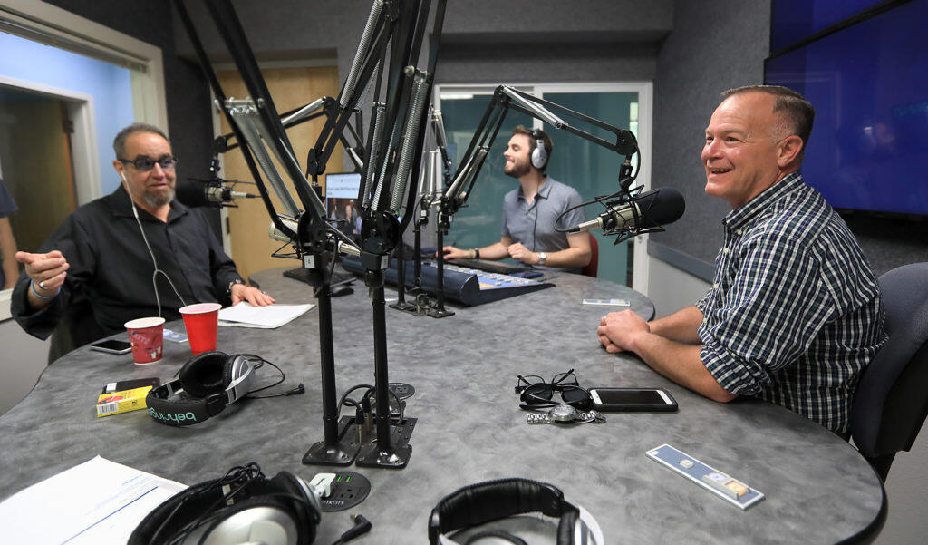 Former Sonoma County Sheriff Mark Essick, right, gives an interview with Steve Jaxon, left, and producer Mike DeWald, middle, at KSRO studios in 2018 in Santa Rosa. (Kent Porter / The Press Democrat file)
