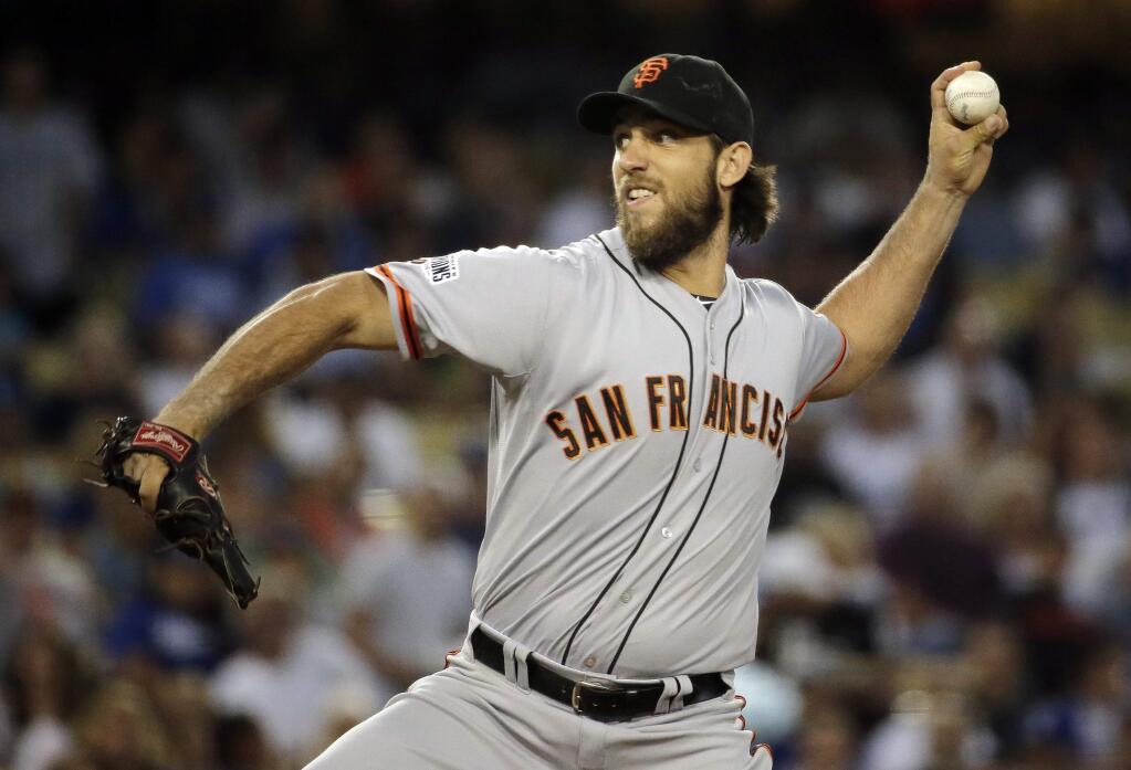 San Francisco Giants' Madison Bumgarner throws against the Los Angeles Dodgers during the first inning of a baseball game in Los Angeles, Tuesday, Sept. 1, 2015. (AP Photo/Chris Carlson)