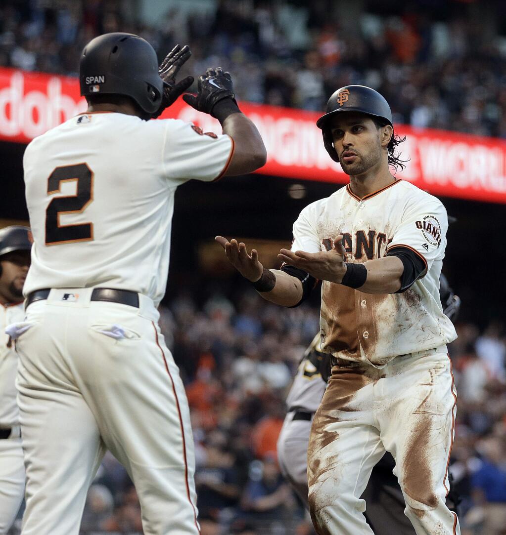 San Francisco Giants Angel Pagan, right, and Denard Span (2) celebrate after scoring against the Pittsburgh Pirates during the first inning Tuesday, Aug. 16, 2016, in San Francisco. Both scored on a double by Buster Posey. (AP Photo/Ben Margot)
