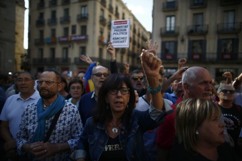People protest the National Court's decision to imprison civil society leaders without bail, in front of the Palau Generalitat in Barcelona, Spain, Tuesday, Oct. 17, 2017. Protesters were gathering for a fresh round of demonstrations in Barcelona Tuesday to demand the release of two leaders of Catalonia's pro-independence movement who were jailed in a sedition probe. (AP Photo/Manu Fernandez)