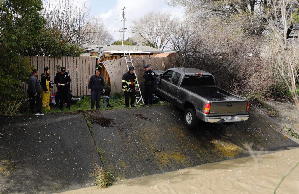 A man driving a pickup truck suffered a medical emergency on Thursday, Feb. 14, 2019, causing him to lose control of his truck and run off the road, smashing through a fence and coming to a stop on the side of the culvert. (Beth Schlanker/Press Democrat)