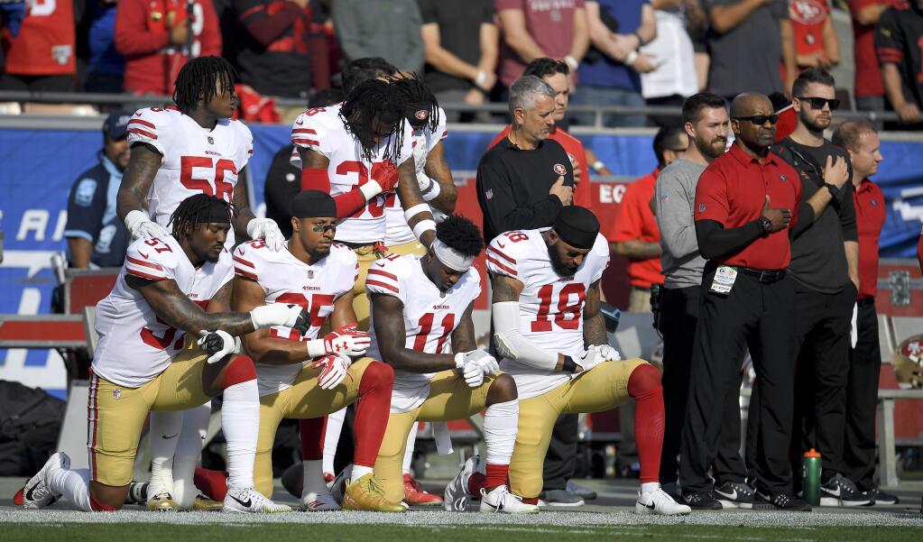 Members of the San Francisco 49ers kneel during the national anthem before a game against the Los Angeles Rams Sunday, Dec. 31, 2017, in Los Angeles. (AP Photo/Mark J. Terrill)