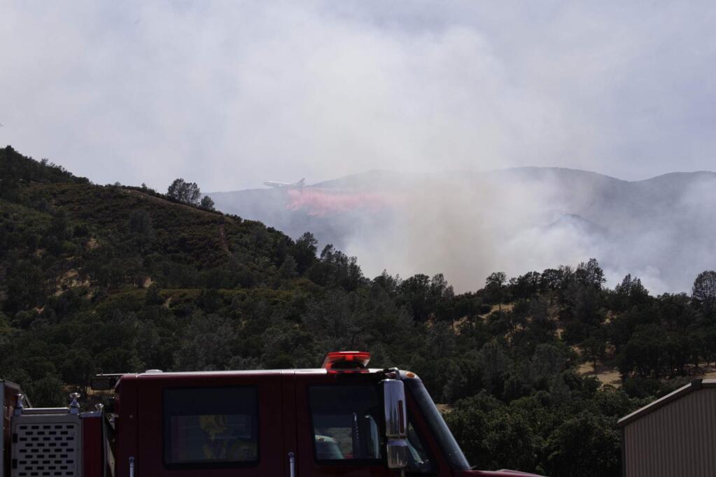 A tanker drops fire retardant on the Sand fire in Yolo County near Rumsey, California after 3 p.m. on Sunday, June 9, 2019. (CRAIG PHILPOTT)
