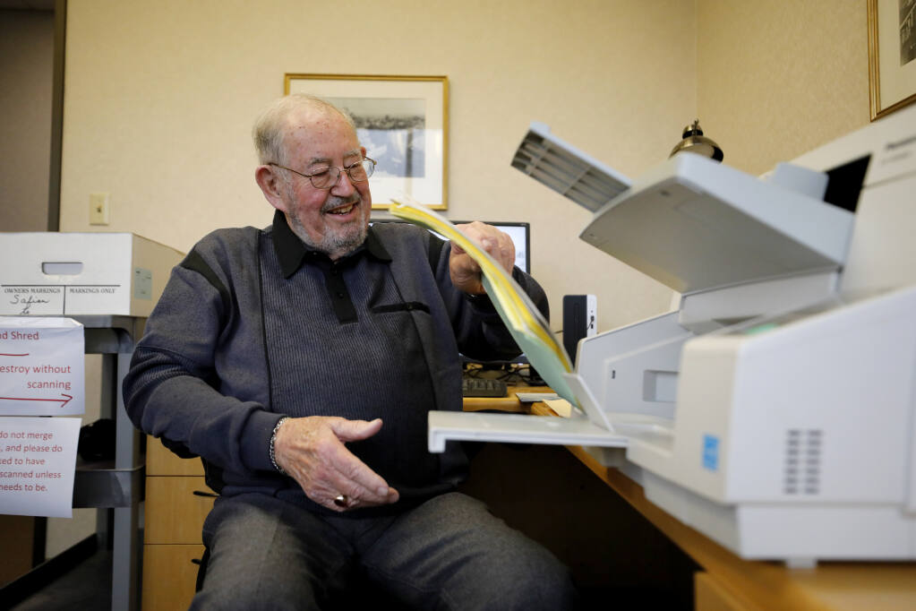 Don Silva scans documents at Anderson Zeigler law firm in Santa Rosa, Calif., on Tuesday, Jan. 4, 2022. (Beth Schlanker / The Press Democrat)