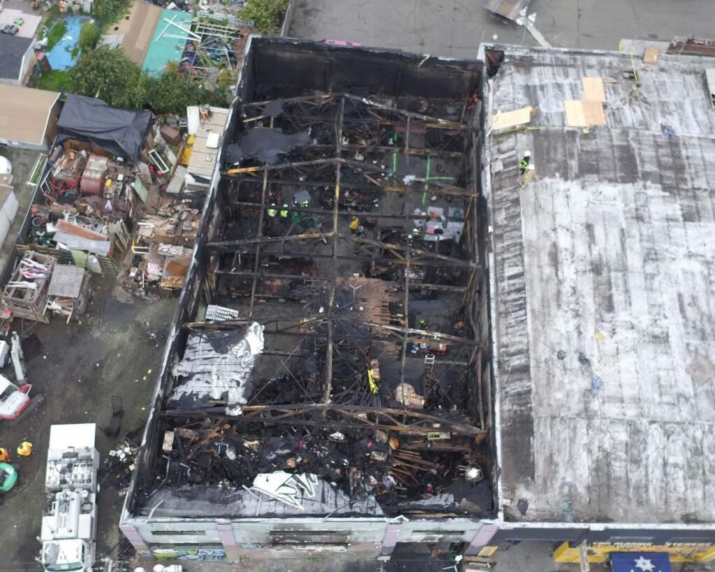 FILE - This undated file photo provided by the City of Oakland shows inside the burned warehouse after the deadly fire that broke out on Dec. 2, 2016, in Oakland, Calif. Two men have pleaded not guilty to involuntary manslaughter charges in connection with a fire in an illegally converted Northern California warehouse that killed 36 people. Derick Almena and Max Harris entered pleas to 36 counts of involuntary manslaughter each, Tuesday, Sept. 26, 2017. (City of Oakland via AP, File)