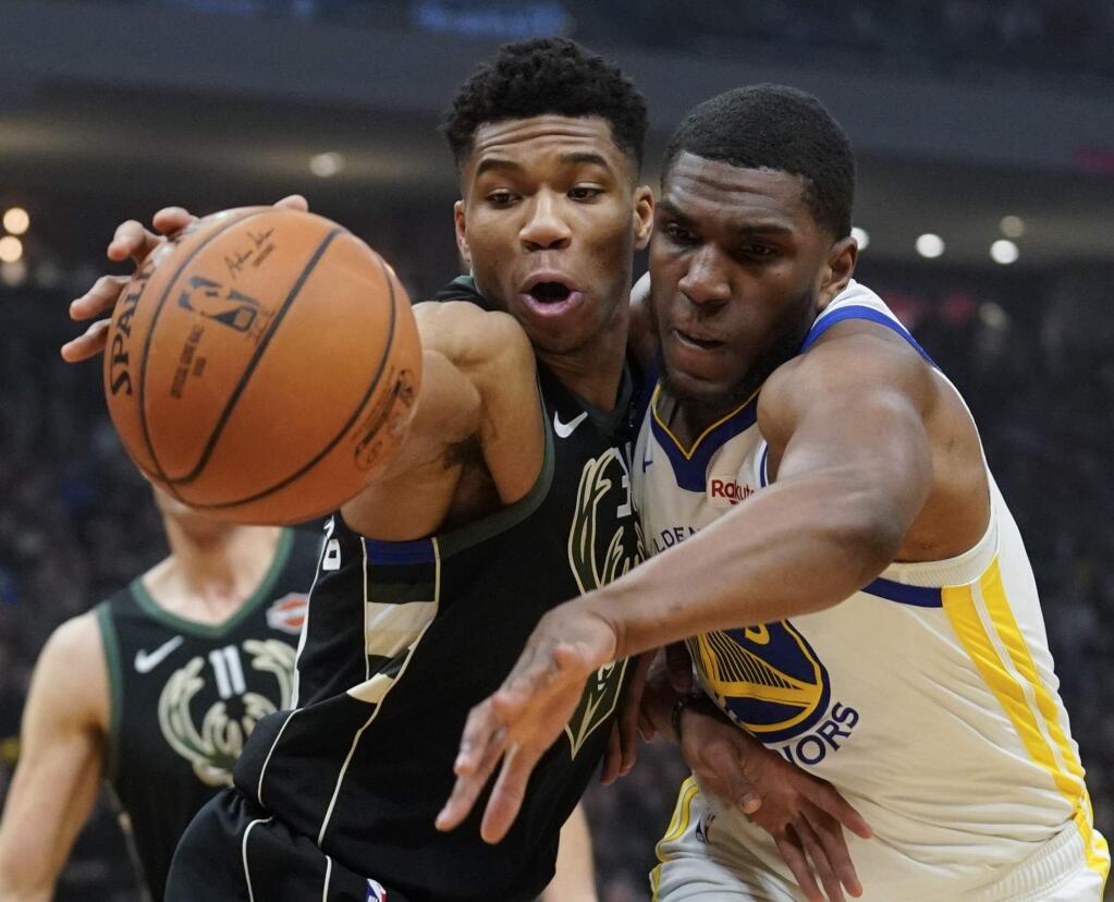 Milwaukee Bucks' Giannis Antetokounmpo and Golden State Warriors' Kevon Looney go after a loose ball during the first half of an NBA basketball game Friday, Dec. 7, 2018, in Milwaukee. (AP Photo/Morry Gash)