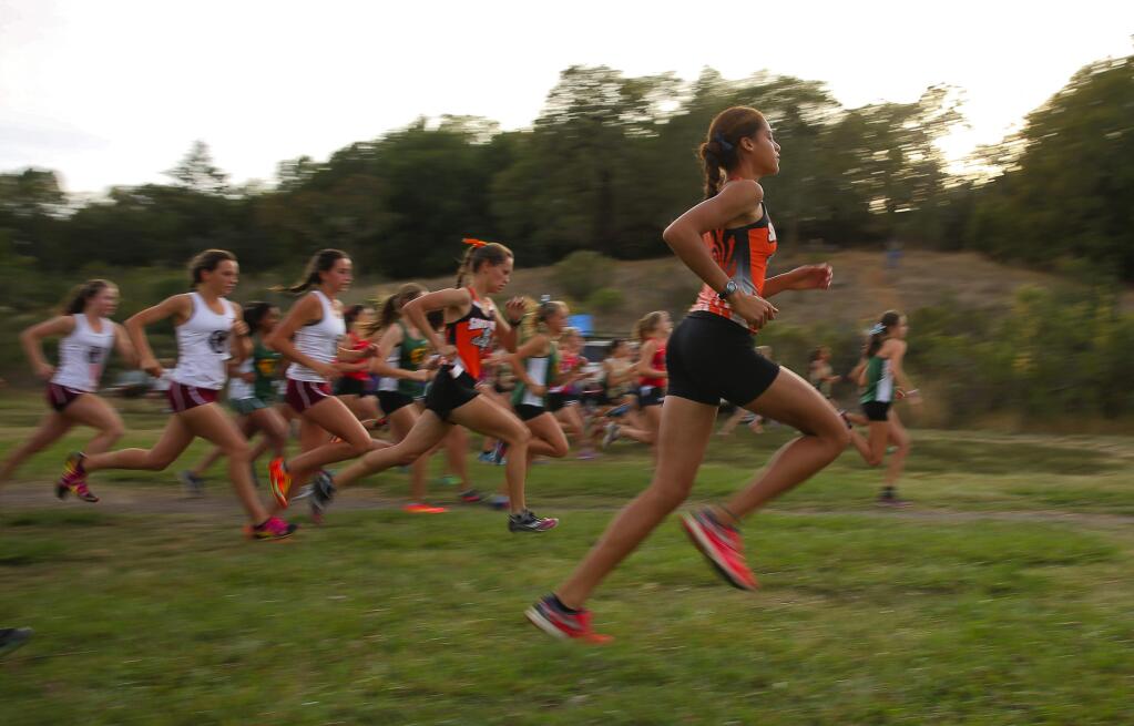 The varsity girls take off at the start of the first NBL center meet at Spring Lake Park, in Santa Rosa, on Wednesday, October 7, 2015. (Christopher Chung/ The Press Democrat)