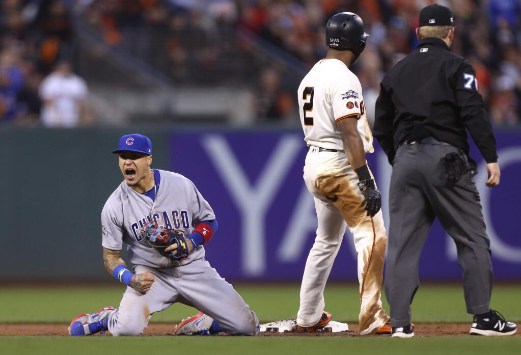 Chicago Cubs' Javier Baez lets out a yell after tagging out San Francisco Giants' Denard Span at second base, in San Francisco, on Tuesday, October 11, 2016. (Christopher Chung/ The Press Democrat)