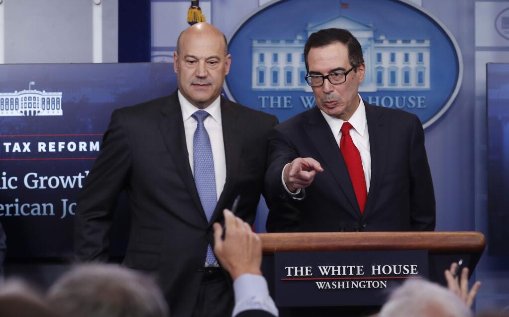 Treasury Secretary Steven Mnuchin, right, joined by National Economic Director Gary Cohn, speaks in the briefing room of the White House, in Washington, Wednesday, April 26, 2017. President Donald Trump is proposing dramatically reducing the taxes paid by corporations big and small in an overhaul his administration says will spur economic growth and bring jobs and prosperity to the middle class. (AP Photo/Carolyn Kaster)