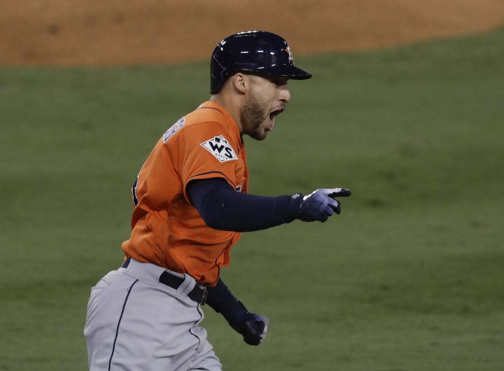 The Houston Astros' George Springer celebrates after his two-run home run against the Los Angeles Dodgers during the second inning of Game 7 of the World Series Wednesday, Nov. 1, 2017, in Los Angeles. (AP Photo/Alex Gallardo)