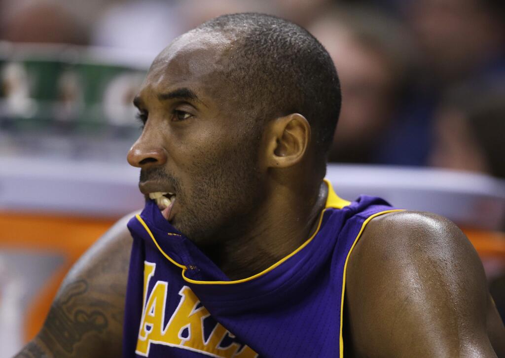 Los Angeles Lakers' Kobe Bryant watches from the bench during the second half of an NBA basketball game against the Indiana Pacers, Monday, Dec. 15, 2014, in Indianapolis. The Pacers won 110-91. (AP Photo/Darron Cummings)