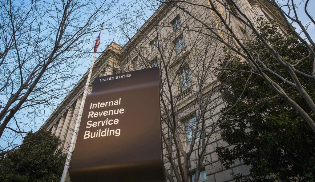 FILE - This April 13, 2014, file photo shows the Internal Revenue Service (IRS) headquarters building in Washington. The Treasury Department and the IRS are urging taxpayers who want to get their economic impact payments directly deposited to their bank accounts to enter their information online by Wednesday, May 13, 2020. The IRS said that people should use the “Get My Payment” tool on the IRS website by noon on Wednesday to provide their direct deposit information. (AP Photo/J. David Ake, File)