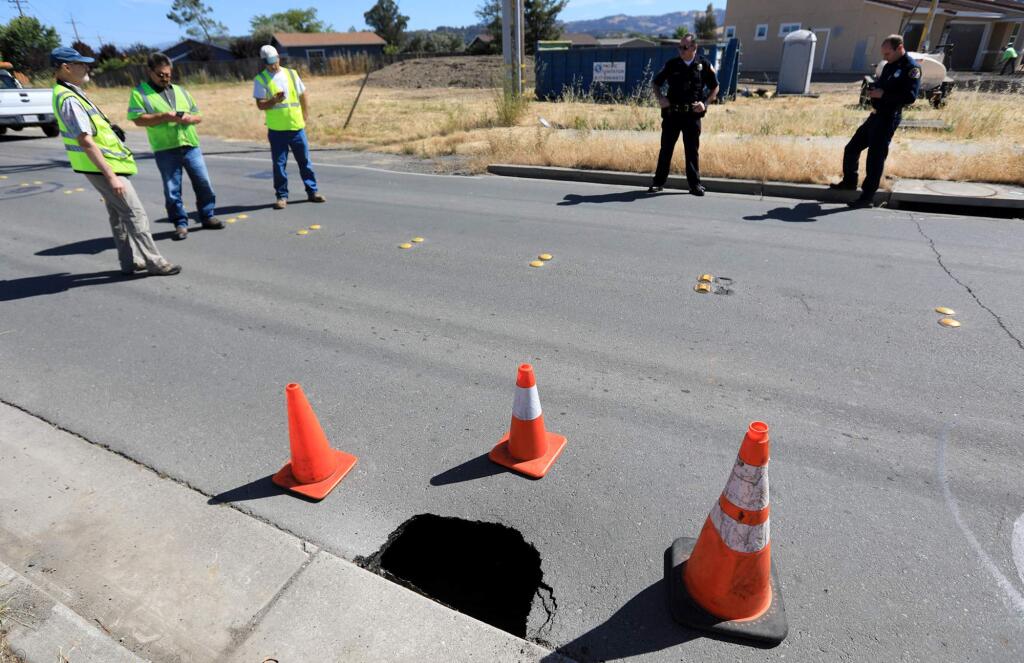 A sinkhole opened up on Barnes Road at Dennis Lane in Santa Rosa, Monday, June 4, 2018, prompting officials to close the road to traffic. (KENT PORTER/ PD)