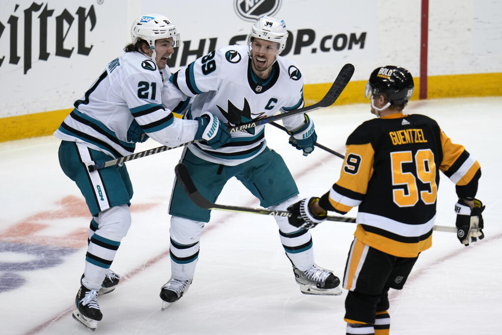 The Sharks’ Logan Couture, center, celebrates his goal with Michael Eyssimont during the third period Saturday against the Penguins in Pittsburgh. (Gene J. Puskar / ASSOCIATED PRESS)