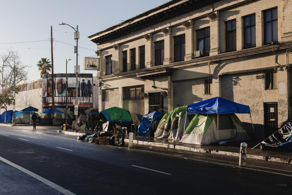 Tents erected along 5th Street in the Skid Row section of Los Angeles, on Feb. 2, 2024. To confront the crises of homelessness and mental illness, California has passed new laws that critics say could violate the civil liberties of those suffering on the streets. Some families welcome the new measures. (Alex Welsh/The New York Times)