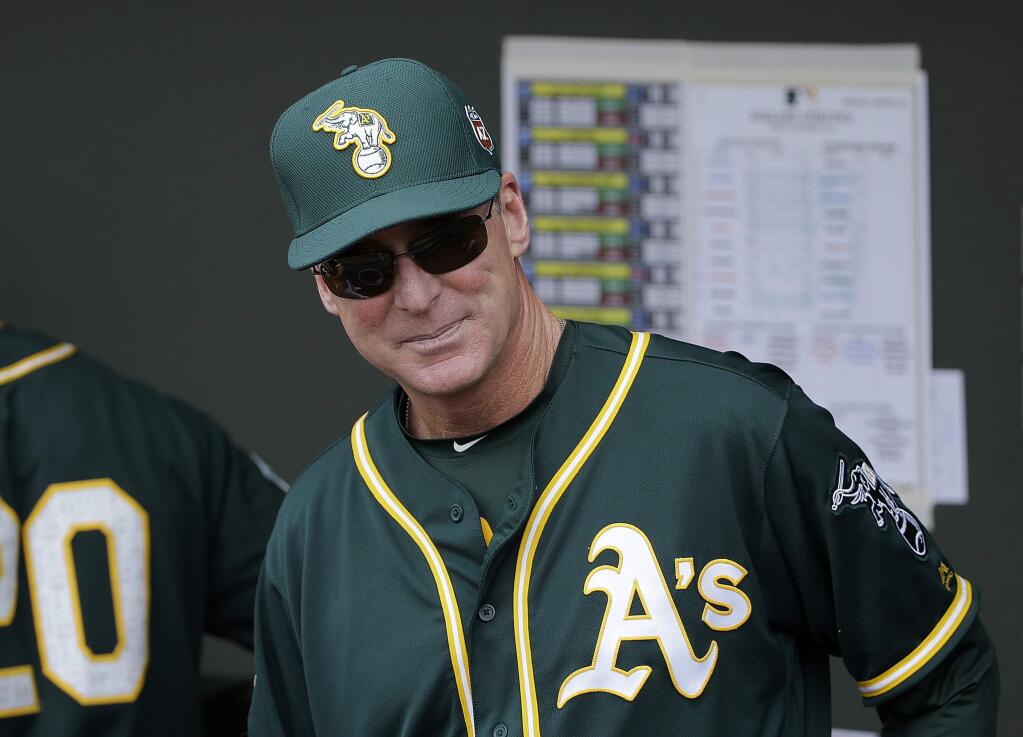 FILE - In this March 28, 2016, file photo, Oakland Athletics manager Bob Melvin watches before a spring training baseball game between the Athletics and the Cleveland Indians in Mesa, Ariz. Melvin has four legitimate closers to choose from and he isn't ready to name any of them his No. 1 option for the ninth inning. (AP Photo/Jeff Chiu, File)