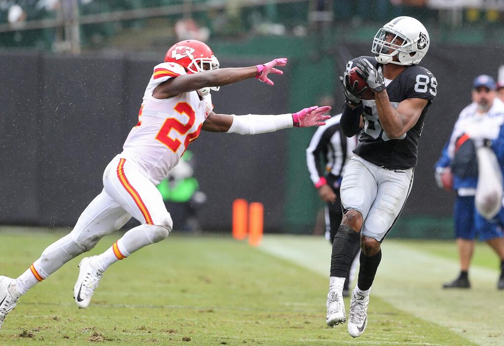 Oakland Raiders wide receiver Amari Cooper makes a catch in front of Kansas City Chiefs cornerback D.J. White during their game in Oakland on Sunday, Oct. 16, 2016. The Raiders lost to the Chiefs 26-10. (Christopher Chung / The Press Democrat)