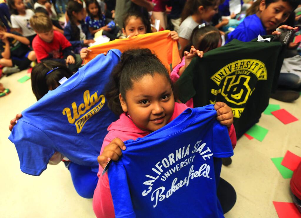 About 125 second- and third-grade Helen Lehman elementary school students received a college t-shirt and a letter Friday from a college grad through The College Tee Project. (JOHN BURGESS / The Press Democrat)