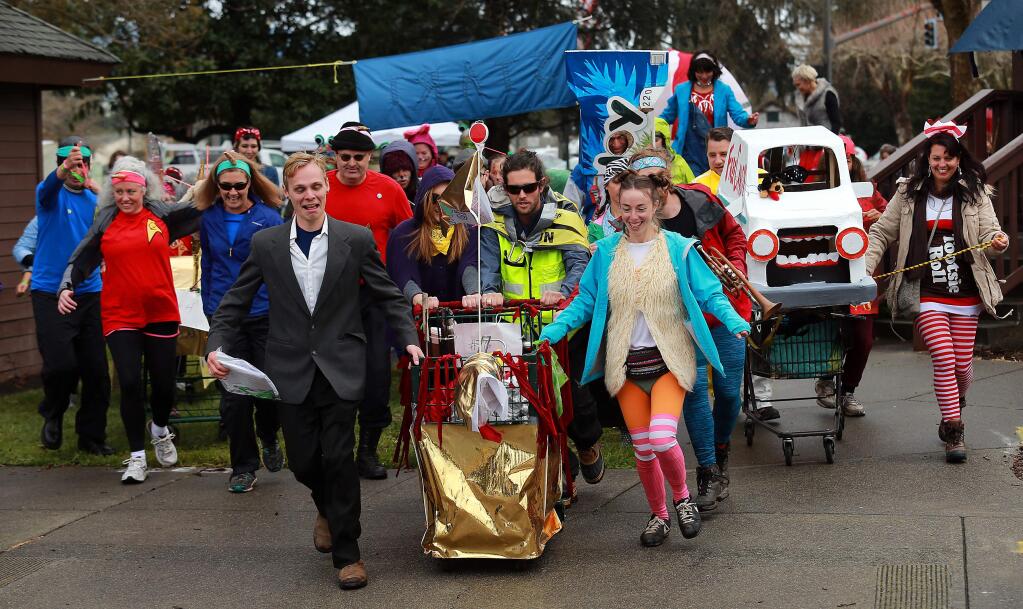 In a race to feed those in need, costumed shopping cart teams sped around Cotati on Saturday afternoon, stopping at five drinking establishments along the way to play games for prizes. Each team donated 60 lbs. of food to the Redwood Empire Food Bank. (John Burgess/The Press Democrat)