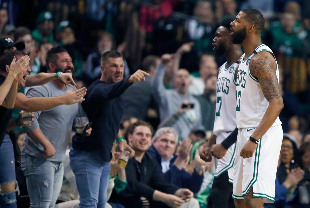 Fans react after Boston Celtics' Marcus Morris (13) was fouled while shooting during the first quarter of Game 1 of a first-round playoff series against the Milwaukee Bucks, in Boston, Sunday, April 15, 2018. (AP Photo/Michael Dwyer)