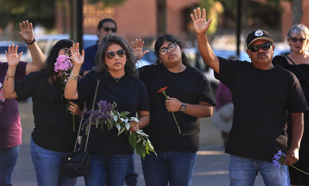 Alfredo Pelaez, right, prays for his brother David Pelaez-Chavez with his family, from left, Yaranaxali Pelaez, Aurora Castro and Nayceht Pelaez, during a vigil Saturday, July 29 at Old Courthouse Square in Santa Rosa. The vigil marked one year since Pelaez-Chavez was shot and killed by a Sonoma County Sheriff’s deputy. (Kent Porter / The Press Democrat)