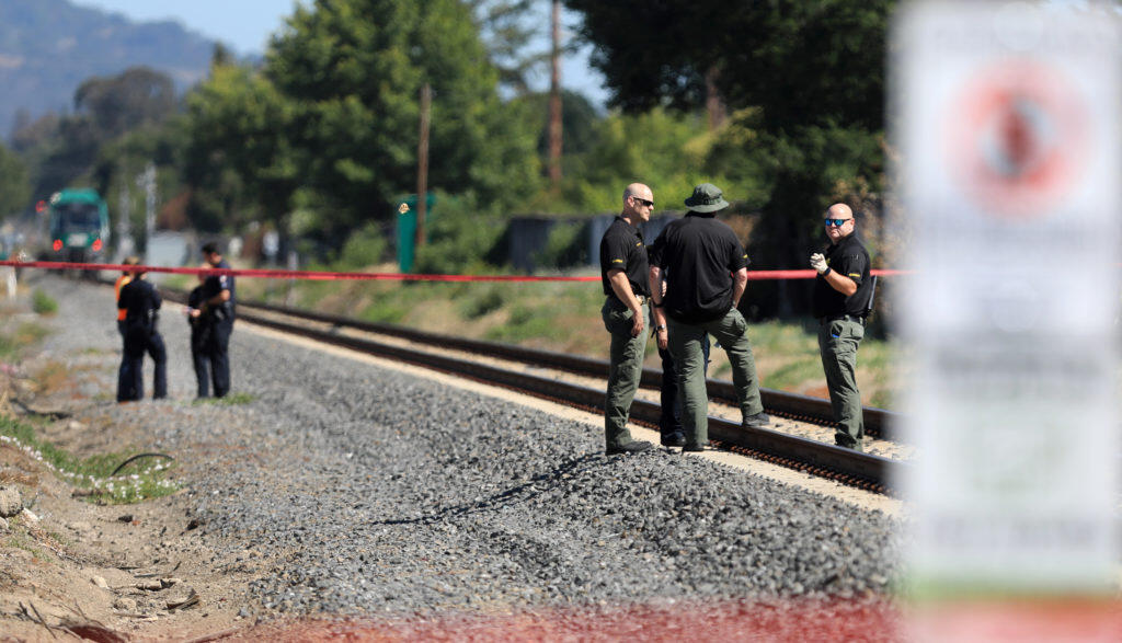 Sonoma County Sheriff and Santa Rosa police officers  begin their investigation in to the death of a pedestrian after being struck by a SMART train, Friday, July 12, 2019 at San Miguel Road in Santa Rosa.  (Kent Porter /  The Press Democrat) 2019
