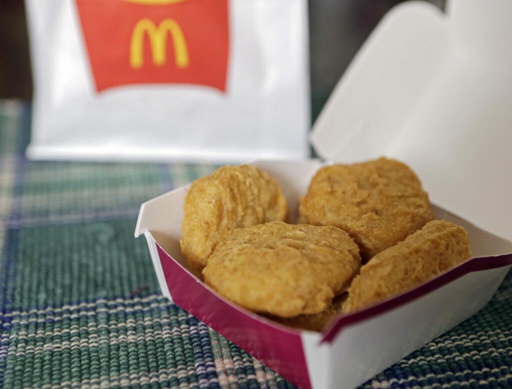 An order of McDonald's Chicken McNuggets is displayed for a photo in Olmsted Falls, Ohio Wednesday, March 4, 2015. McDonald's says it plans to start using chicken raised without antibiotics important to human medicine and milk from cows that are not treated with the artificial growth hormone rbST.. (AP Photo/Mark Duncan)