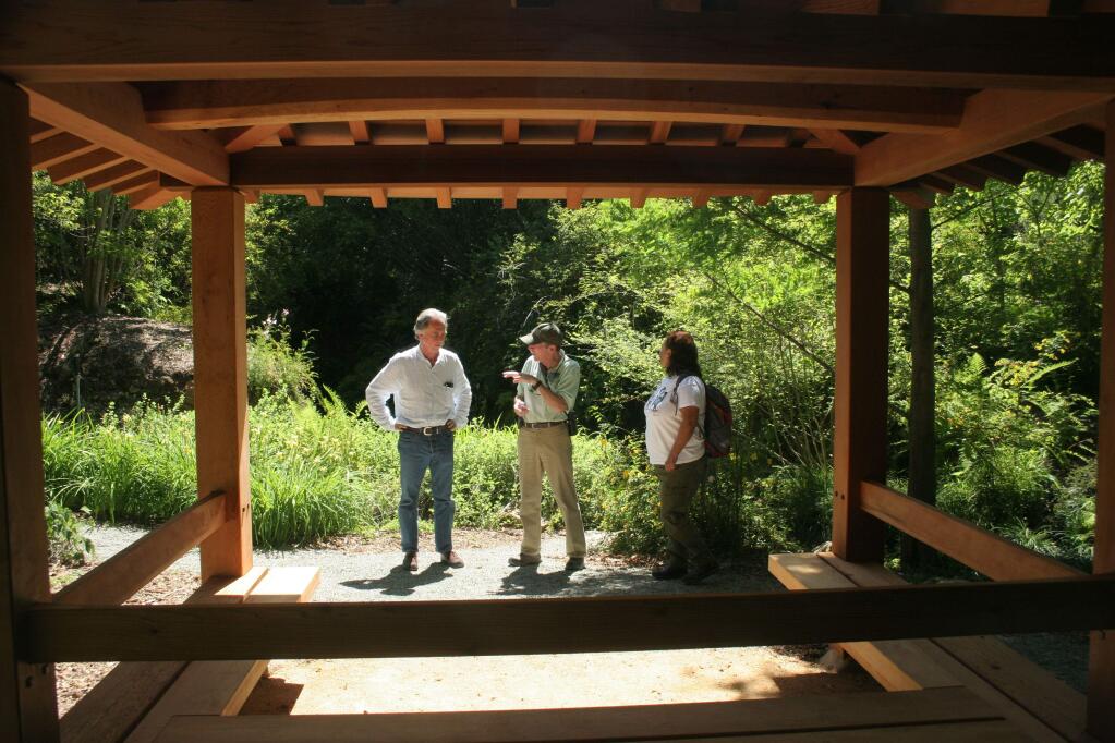 Quarryhill's executive director William McNamara, left, talks with Quarryhill volunteers at a new Japanese 'ting' in the botanical garden. (Christian Kallen/Index-Tribune)