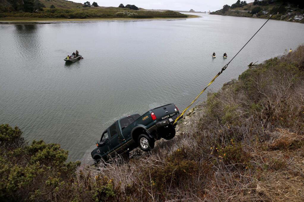 A pickup truck is pulled from the Russian River after it plunged into the water, causing two sisters, ages 4 and 7, to drown. Photo taken in Jenner, on Tuesday, August 23, 2016. (BETH SCHLANKER/ The Press Democrat)