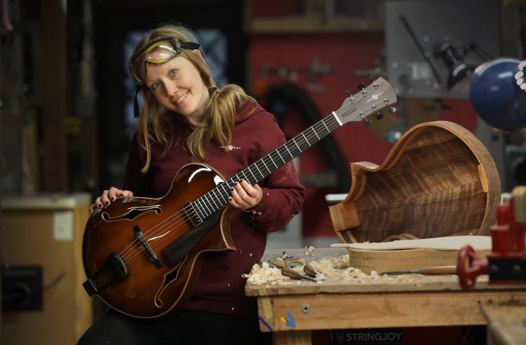 Guitar maker Maegen Wells in her workshop in Forestville on Tuesday, Dec. 28, 2021.(Beth Schlanker/The Press Democrat)