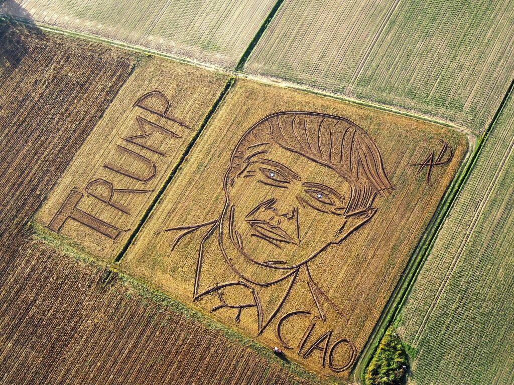In this photo taken on Tuesday, Oct. 25, 2016, an aerial view of a giant portrait of U.S. Republican Presidential nominee Donald Trump. Italian land artist Dario Gambarin has used his tractor to transform a field near the Italian city of Verona into a giant portrait of Donald Trump. This artist created a similar portrait for Democratic nominee Hillary Clinton in September. Gambarin created the portrait on a 25,000-square-meter field, writing ‘'Ciao,'' beneath Trump's left shoulder, signifying recent polls that show Clinton leading the race. (Dario Gambarin via AP)