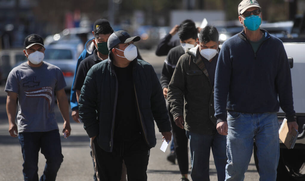 A group of farmworkers from Peay Vineyard of Annapolis arrive at the Sonoma County Fairgrounds in Santa Rosa, Friday, March 19, 2021 to get their second Moderna vaccine. (Kent Porter / The Press Democrat) 2021