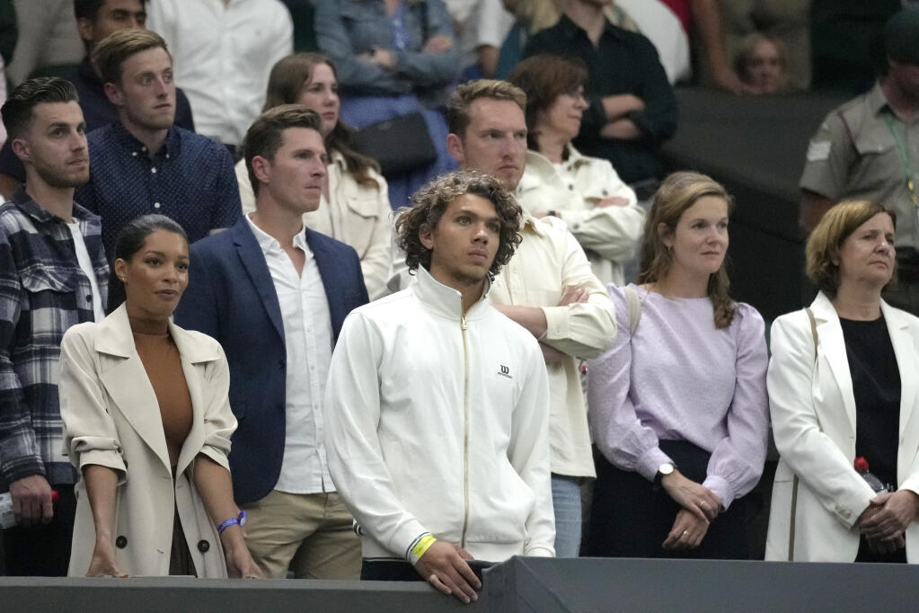 Boris Becker's son Elias and girlfriend Lily, left, stand at the end of a fourth round men's singles match between Serbia's Novak Djokovic and Tim van Rijthoven of the Netherlands on day seven of the Wimbledon tennis championships in London, Sunday, July 3, 2022.(AP Photo/Kirsty Wigglesworth)