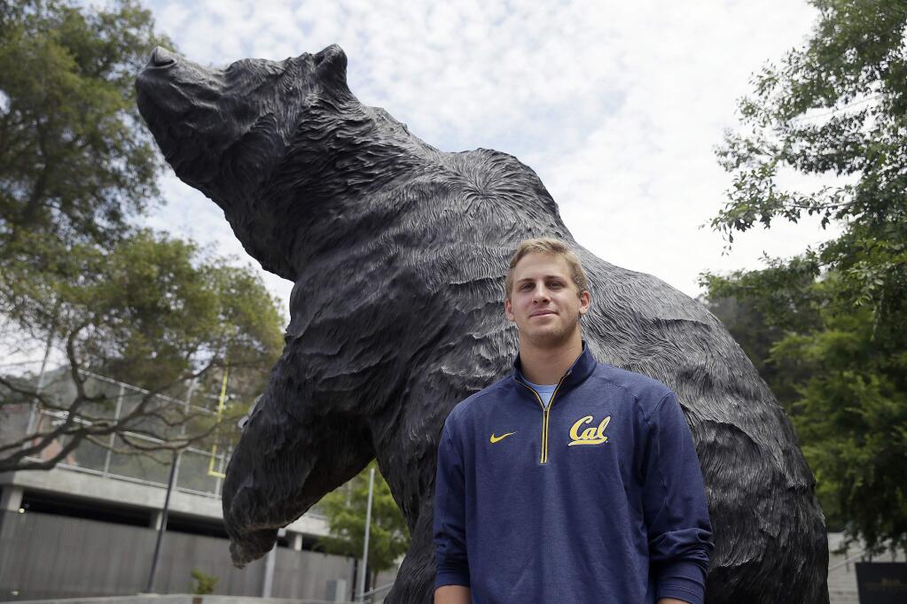 In this photo taken Monday, July 20, 2015, California quarterback Jared Goff poses by a sculpture of a bear outside Memorial Stadium in Berkeley, Calif. Heading into his junior season, Goff feels right at home at Cal with an more control of the offense and the teammates around him to get the Bears back in contention in the Pac-12(AP Photo/Eric Risberg)